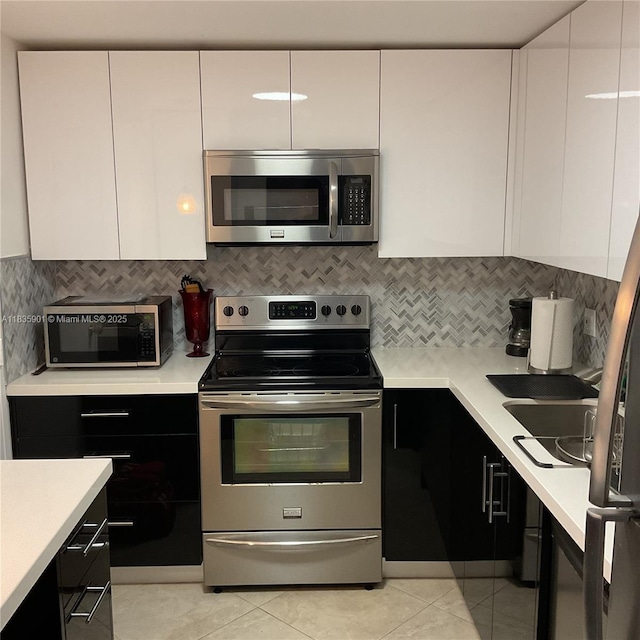 400 Kings Point Dr Unit 623, Sunny Isles Beach, FL 33160 - kitchen featuring appliances with stainless steel finishes, modern cabinets, light countertops, and white cabinetry