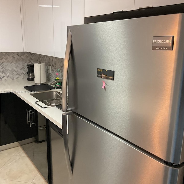 400 Kings Point Dr Unit 623, Sunny Isles Beach, FL 33160 - kitchen featuring freestanding refrigerator, light countertops, white cabinetry, and modern cabinets