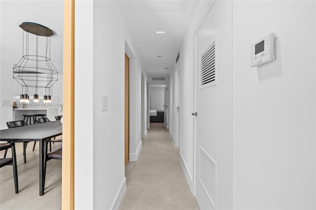 9033 Emerson Ave, Surfside, FL 33154 - corridor featuring baseboards and finished concrete flooring