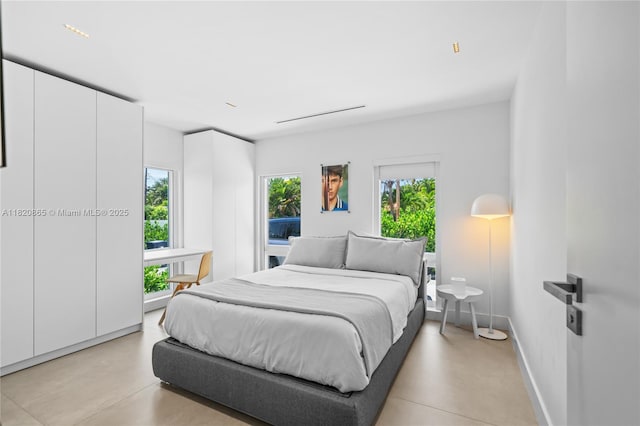 9033 Emerson Ave, Surfside, FL 33154 - bedroom featuring concrete flooring and baseboards