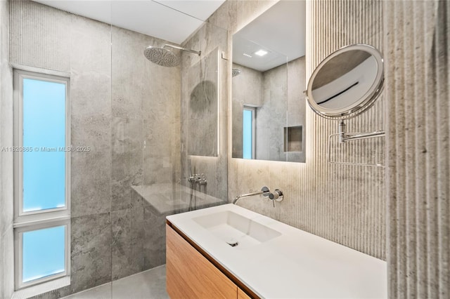 9033 Emerson Ave, Surfside, FL 33154 - bathroom with tile walls, walk in shower, and vanity
