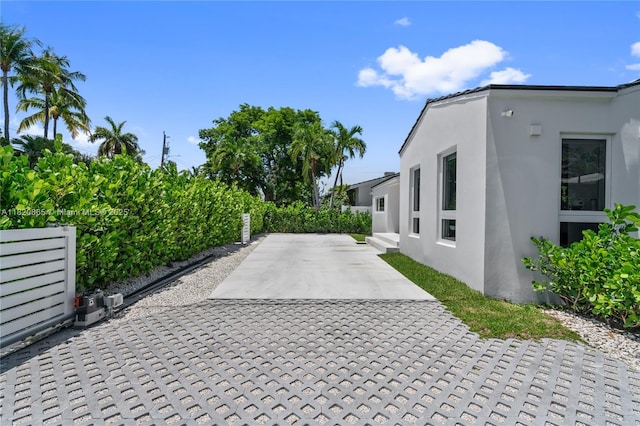 9033 Emerson Ave, Surfside, FL 33154 - view of home's exterior with stucco siding and a patio area
