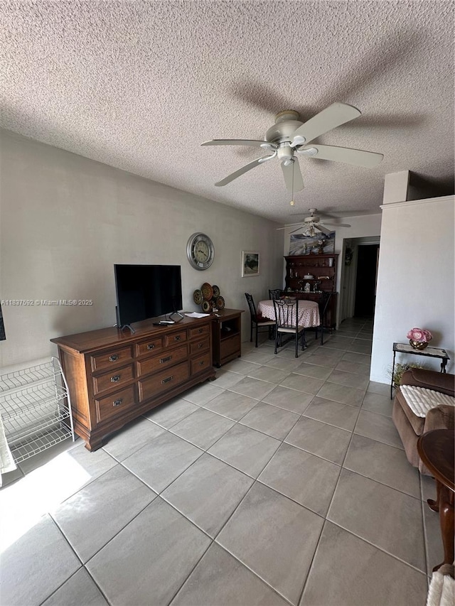 920 SW 11th Ave Unit 12A, Hallandale Beach, FL 33009 - living area featuring ceiling fan, light tile patterned flooring, and a textured ceiling