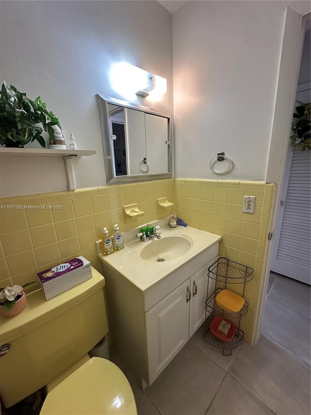 920 SW 11th Ave Unit 12A, Hallandale Beach, FL 33009 - bathroom with tile walls, tile patterned flooring, vanity, and wainscoting