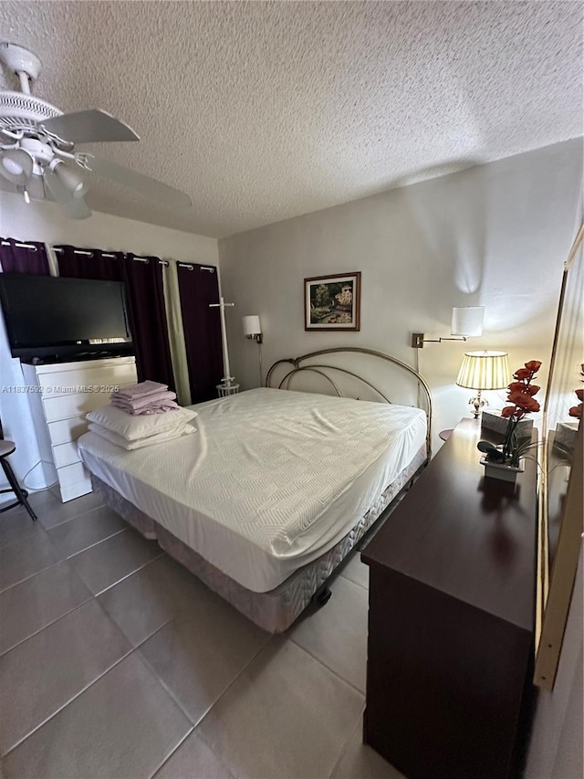 920 SW 11th Ave Unit 12A, Hallandale Beach, FL 33009 - bedroom featuring a textured ceiling and dark tile patterned floors