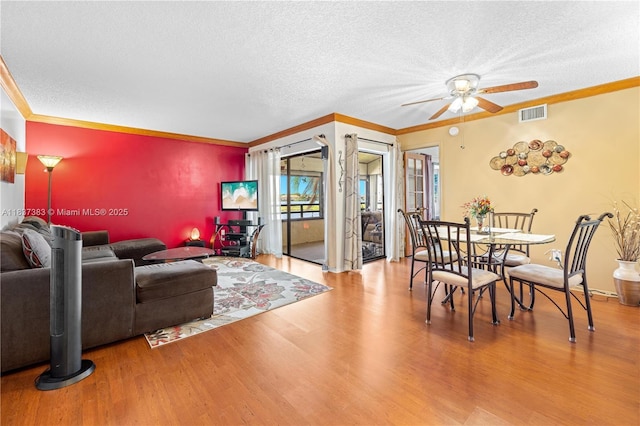 20145 NE 3rd Ct Unit 2, Miami, FL 33179 - dining area with a ceiling fan, wood finished floors, crown molding, and a textured ceiling
