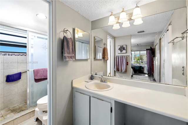 20145 NE 3rd Ct Unit 2, Miami, FL 33179 - ensuite bathroom featuring a textured ceiling, vanity, a shower stall, and tile patterned flooring