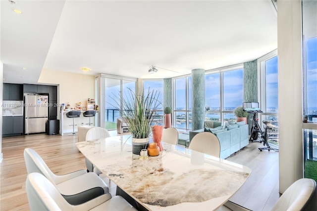 244 Biscayne Blvd Unit 4803, Miami, FL 33132 - dining space featuring light wood-type flooring, plenty of natural light, and floor to ceiling windows