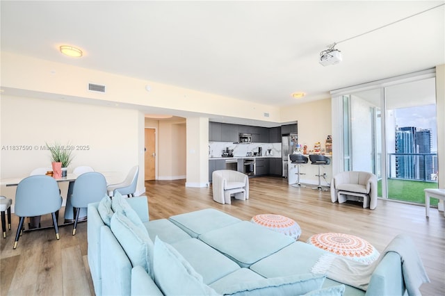 244 Biscayne Blvd Unit 4803, Miami, FL 33132 - living room with light wood-style flooring and floor to ceiling windows