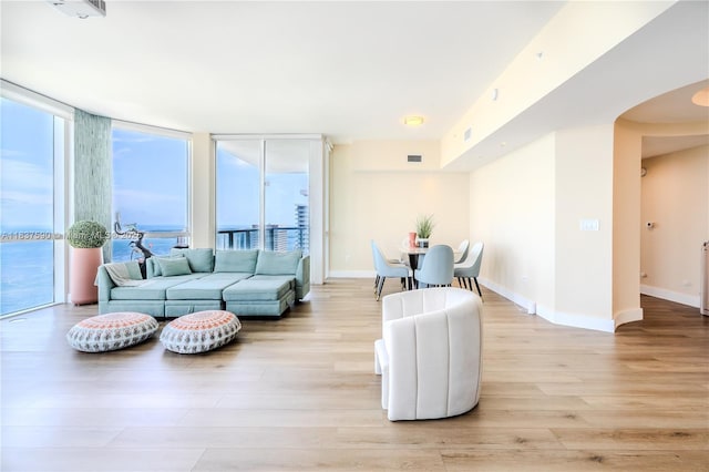 244 Biscayne Blvd Unit 4803, Miami, FL 33132 - living area with light wood finished floors, arched walkways, and expansive windows