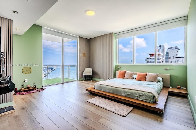 244 Biscayne Blvd Unit 4803, Miami, FL 33132 - bedroom with access to exterior, multiple windows, wood finished floors, and expansive windows
