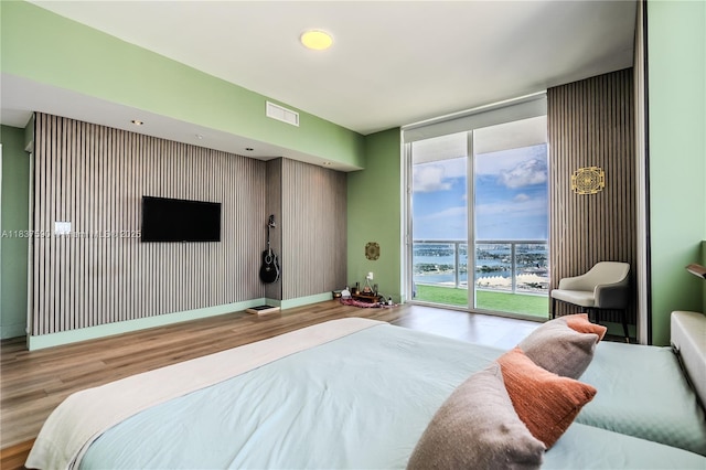 244 Biscayne Blvd Unit 4803, Miami, FL 33132 - bedroom featuring wood finished floors, a wall of windows, and access to exterior
