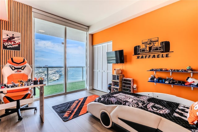 244 Biscayne Blvd Unit 4803, Miami, FL 33132 - bedroom featuring wood finished floors, floor to ceiling windows, an office area, a closet, and access to exterior