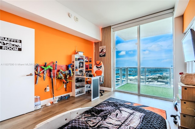 244 Biscayne Blvd Unit 4803, Miami, FL 33132 - bedroom featuring a wall of windows, access to outside, multiple windows, and wood finished floors