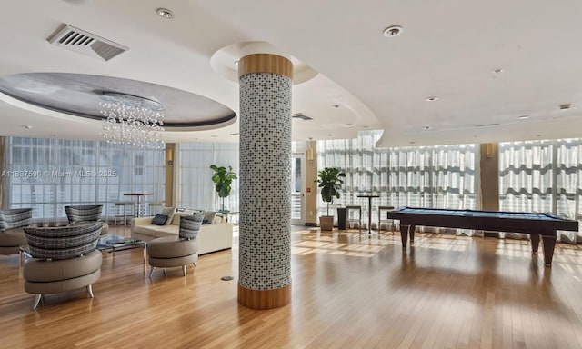 244 Biscayne Blvd Unit 4803, Miami, FL 33132 - recreation room with expansive windows, hardwood / wood-style flooring, healthy amount of natural light, pool table, and a chandelier