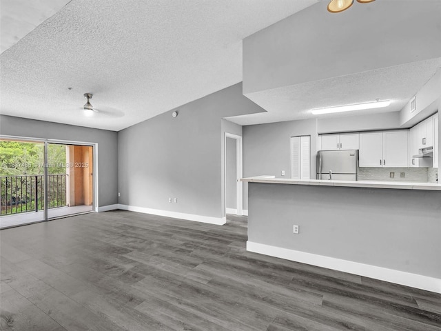 2071 Renaissance Blvd Unit 303, Miramar, FL 33025 - unfurnished living room featuring dark wood-style floors, a textured ceiling, and ceiling fan