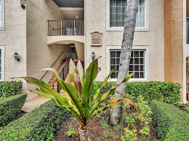 2071 Renaissance Blvd Unit 303, Miramar, FL 33025 - view of exterior entry with stucco siding and a balcony