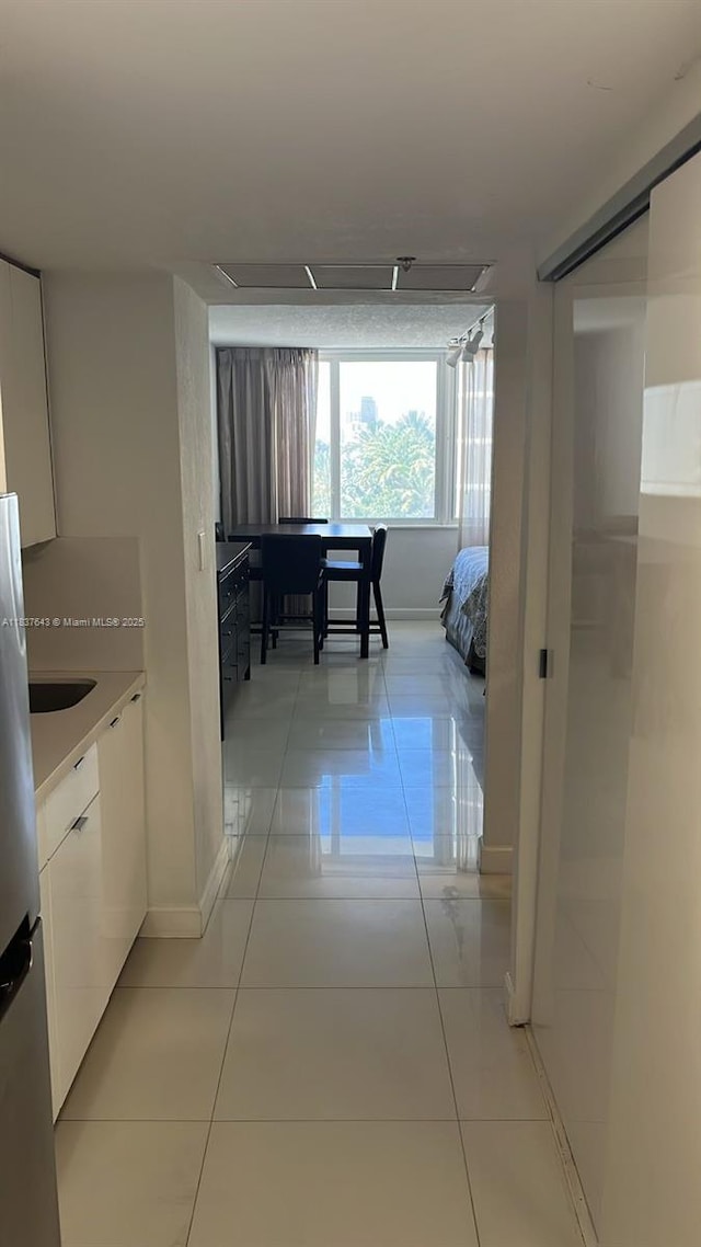 19201 Collins Ave Unit 330, Sunny Isles Beach, FL 33160 - corridor featuring light tile patterned flooring and baseboards