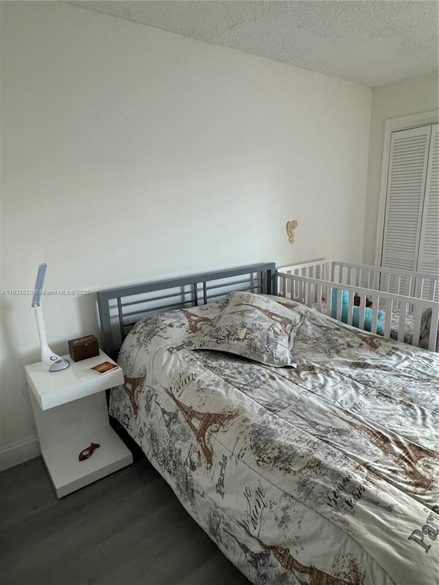 9986 Royal Palm Blvd Unit 9986, Coral Springs, FL 33065 - bedroom with wood finished floors and a textured ceiling