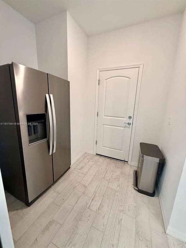 4468 Spruce Ln, Oakland Park, FL 33309 - kitchen with stainless steel fridge with ice dispenser and light wood-type flooring