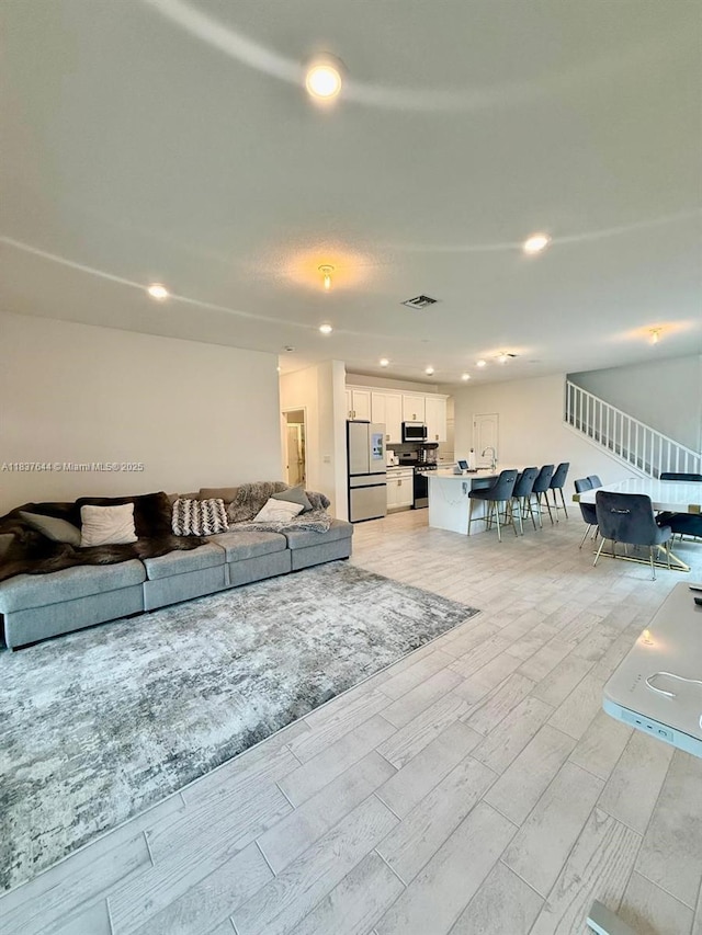 4468 Spruce Ln, Oakland Park, FL 33309 - living room with wood finish floors, stairs, and recessed lighting