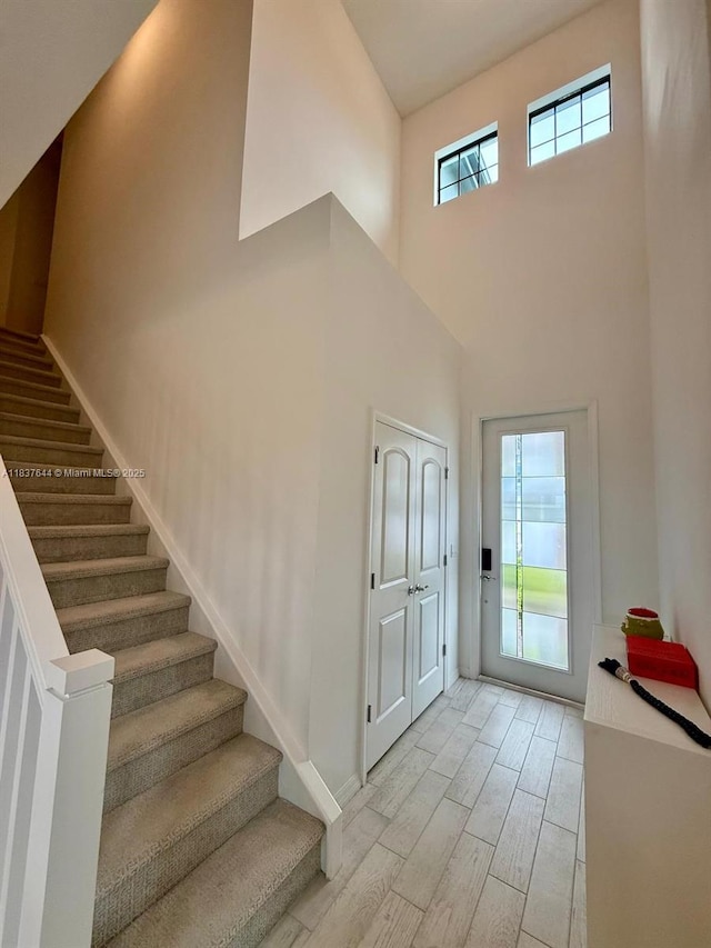 4468 Spruce Ln, Oakland Park, FL 33309 - entrance foyer featuring light wood-style flooring, stairway, and a towering ceiling