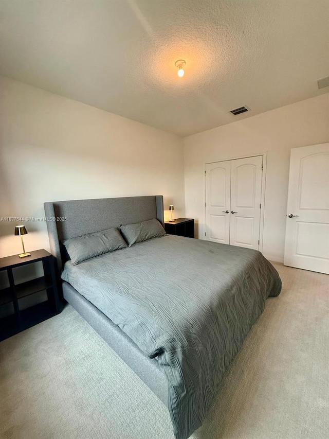 4468 Spruce Ln, Oakland Park, FL 33309 - bedroom with light carpet, a textured ceiling, and a closet