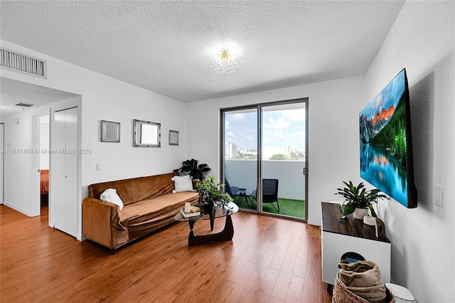 36 NW 6th Ave Unit 701, Miami, FL 33128 - living area with wood finished floors and a textured ceiling