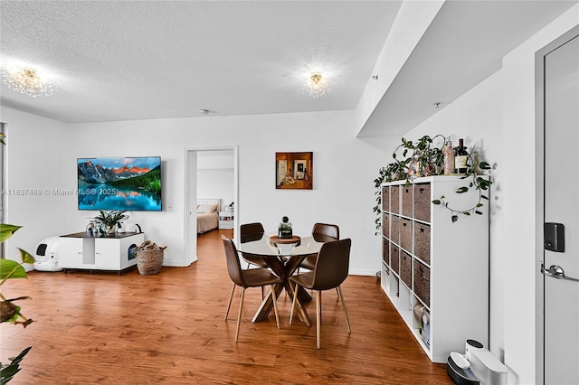 36 NW 6th Ave Unit 701, Miami, FL 33128 - dining area featuring wood finished floors and a textured ceiling