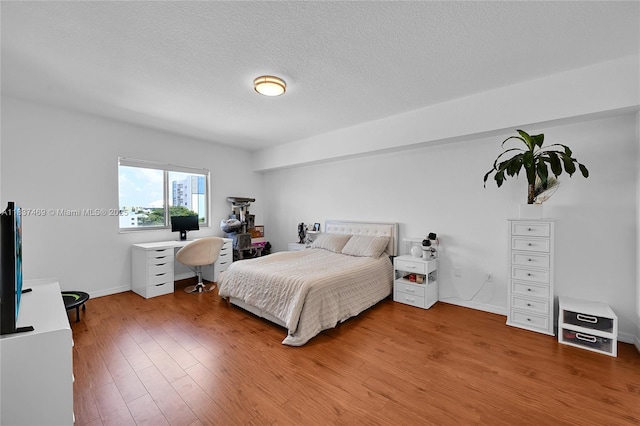 36 NW 6th Ave Unit 701, Miami, FL 33128 - bedroom featuring wood finished floors, a desk, and a textured ceiling