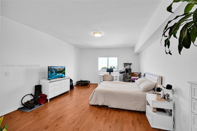 36 NW 6th Ave Unit 701, Miami, FL 33128 - bedroom featuring wood finished floors and a textured ceiling