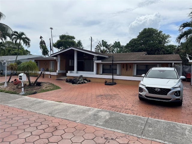 5372 W 9th Ave, Hialeah, FL 33012 - view of front of home featuring driveway and roof with shingles