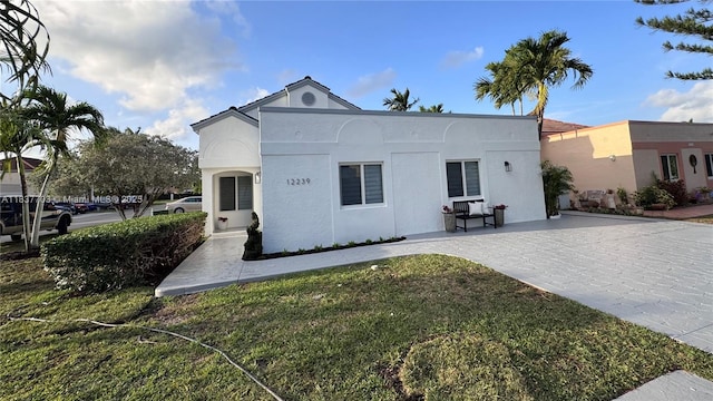 12239 NW 7th St, Miami, FL 33182 - view of front of house featuring stucco siding and a front lawn