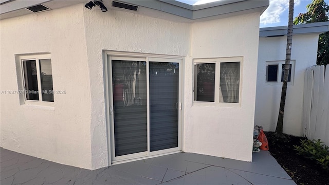 12239 NW 7th St, Miami, FL 33182 - property entrance featuring stucco siding and a patio