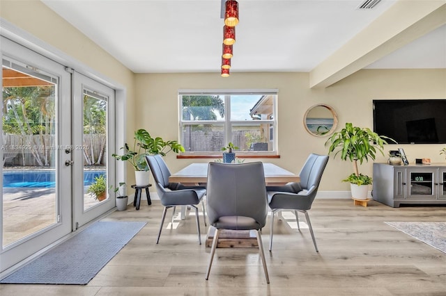 1533 Shenandoah St, Hollywood, FL 33020 - dining space with healthy amount of natural light, wood finished floors, and french doors