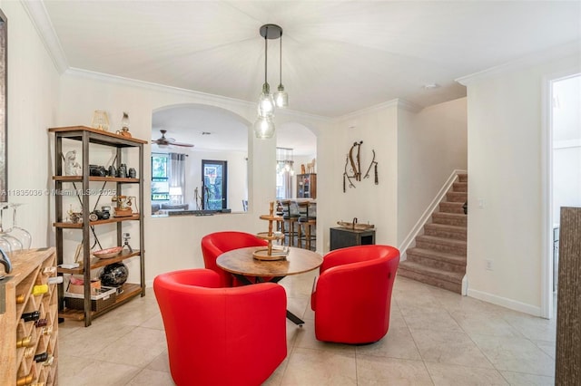 12125 S Vaquero Trails Dr, Davie, FL 33325 - dining area with arched walkways, stairs, crown molding, a ceiling fan, and tile patterned floors