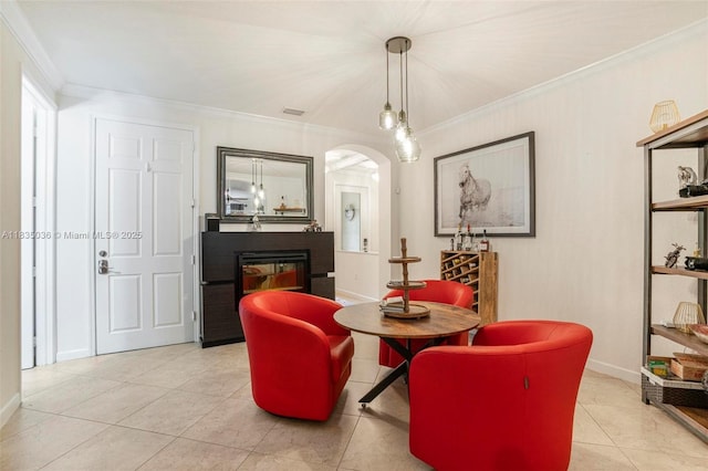 12125 S Vaquero Trails Dr, Davie, FL 33325 - sitting room with arched walkways, ornamental molding, a glass covered fireplace, and light tile patterned flooring