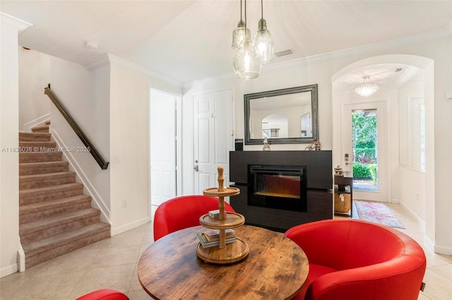 12125 S Vaquero Trails Dr, Davie, FL 33325 - living area with stairway, arched walkways, a glass covered fireplace, tile patterned floors, and crown molding