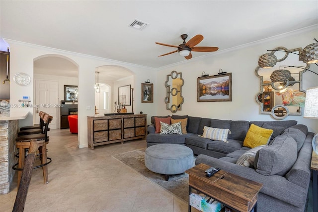 12125 S Vaquero Trails Dr, Davie, FL 33325 - living area with arched walkways, a ceiling fan, ornamental molding, and light tile patterned floors
