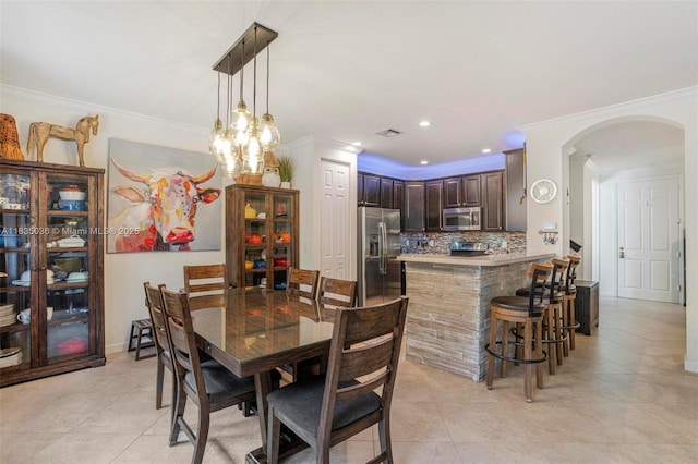 12125 S Vaquero Trails Dr, Davie, FL 33325 - dining room with arched walkways, crown molding, light tile patterned floors, and recessed lighting