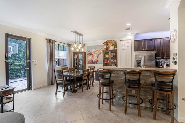 12125 S Vaquero Trails Dr, Davie, FL 33325 - dining room featuring crown molding, a chandelier, and light tile patterned floors