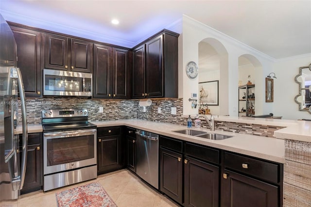 12125 S Vaquero Trails Dr, Davie, FL 33325 - kitchen with stainless steel appliances, backsplash, light countertops, crown molding, and light tile patterned flooring