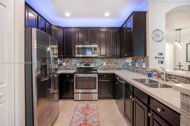 12125 S Vaquero Trails Dr, Davie, FL 33325 - kitchen with stainless steel appliances, arched walkways, decorative backsplash, ornamental molding, and light tile patterned flooring