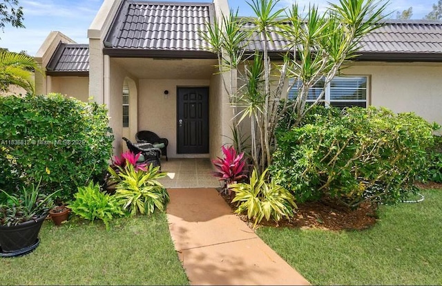 103 Lake Terry Dr, West Palm Beach, FL 33411 - entrance to property featuring stucco siding and a tile roof