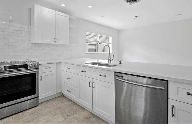 103 Lake Terry Dr, West Palm Beach, FL 33411 - kitchen with appliances with stainless steel finishes, open shelves, light countertops, white cabinetry, and recessed lighting