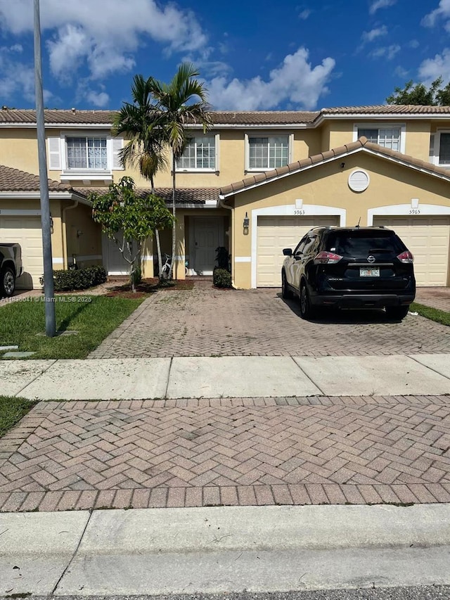 5963 Royal Way, Tamarac, FL 33321 - multi unit property with decorative driveway, stucco siding, a tiled roof, and a garage
