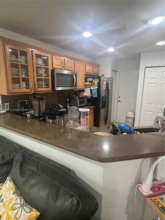 5963 Royal Way, Tamarac, FL 33321 - kitchen with stainless steel appliances, glass insert cabinets, a peninsula, recessed lighting, and brown cabinetry