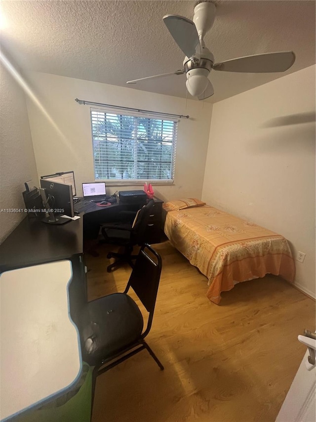 5963 Royal Way, Tamarac, FL 33321 - bedroom featuring a textured ceiling, wood finished floors, a desk, and ceiling fan