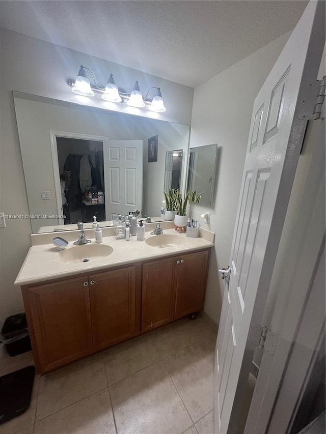 5963 Royal Way, Tamarac, FL 33321 - bathroom with tile patterned floors, double vanity, and a textured ceiling