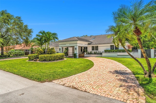 17940 SW 83rd Ave, Palmetto Bay, FL 33157 - view of front of property with stucco siding, a fenced front yard, and decorative driveway